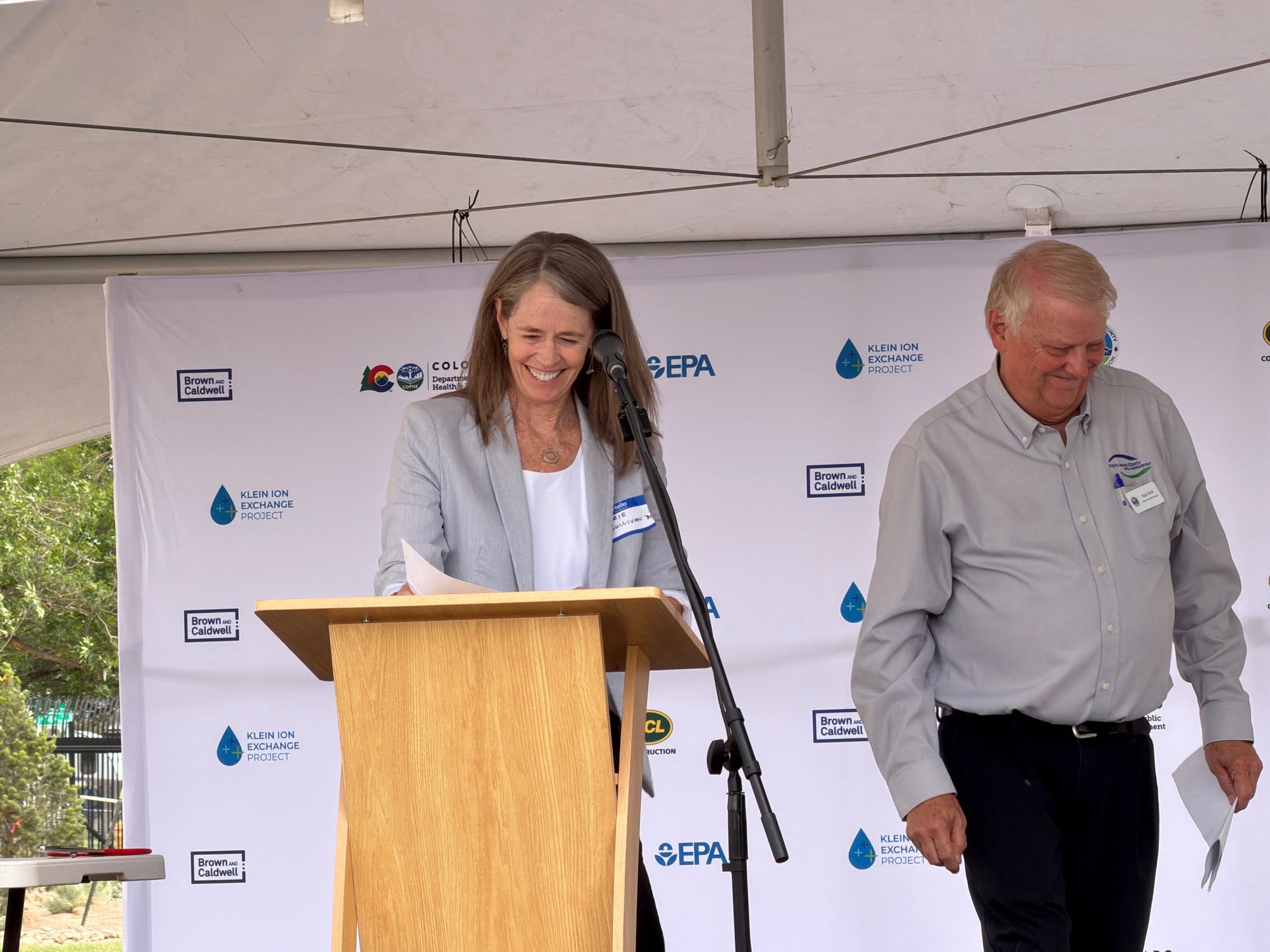 Laurie Sullivan (left) takes the podium after Kipp Scott (right) to speak at the ribbon-cutting ceremony.